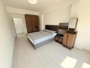 a bedroom with a bed and a dresser and a mirror at EasyStay by Fuat in Struga