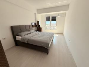 a bedroom with a large bed and a window at EasyStay by Fuat in Struga