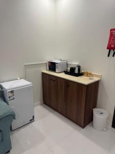 a kitchen with a microwave on top of a counter at شقق الخزامى in Al Baha