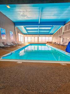 a large swimming pool in a large building at Heritage House Inn on Cape Cod, an Ascend Collection Hotel in Hyannis
