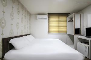 Postel nebo postele na pokoji v ubytování Hotel CL