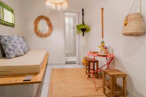 a living room with a couch and a table at Chalé dos Ventos Preá - CE in Cruz +7 photos