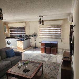 a living room with a couch and a table at Eyad's Apartment in Amman