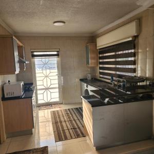 a kitchen with a sink and a counter top at Eyad's Apartment in Amman