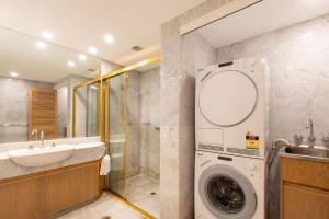 a bathroom with a washing machine and a sink at Mirage Resort Villa 157 with access to Sheraton Facilities in Port Douglas