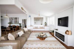 a living room with a couch and a table at Sea Cliff Sands Gerroa in Gerroa