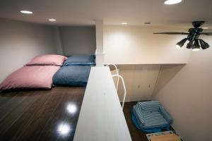 a bedroom with a bed and a ceiling fan at 103 Cassini in Chiba