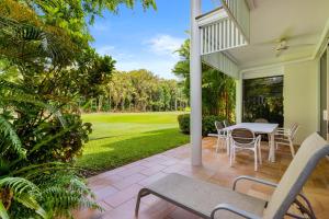 a patio with a table and chairs on a house at Mirage Resort Villa 158 with access to Sheraton Facilities in Port Douglas