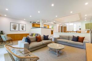 a living room with two couches and a table at Mirage Resort Villa 158 with access to Sheraton Facilities in Port Douglas