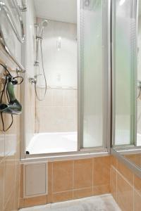 a bathroom with a shower with a window and a tub at PARK! Nezavisimosti 78 in Minsk