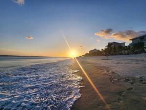 a beach with the sun rising over the ocean at Oceanfront, Caracol Beach in Chame