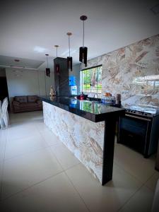 a kitchen with a counter top in a room at Sítio Recanto da Serra in Mateus Leme