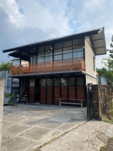 a large building with a bench in front of it at Villa Black Oren in Cireungit