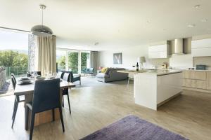 a kitchen and living room with a table and chairs at Take Five in Ambleside