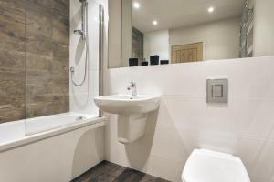 a white bathroom with a sink and a toilet at Take Five in Ambleside +23 photos