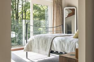 a bedroom with a bed and a large window at Take Five in Ambleside