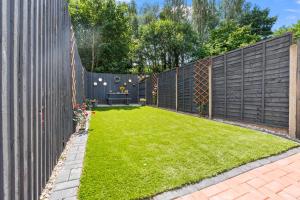 a backyard with a fence and a grass yard at Free Parking ,Modern 4 bedrooms 10min from Birmingham city centre ideal for contractors ,Groups and Families in Birmingham