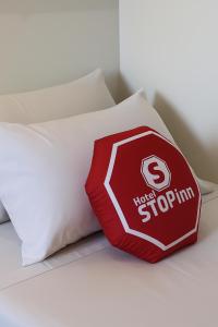 a pillow with a stop sign on it on a bed at Stop Inn Antonio Carlos in Belo Horizonte