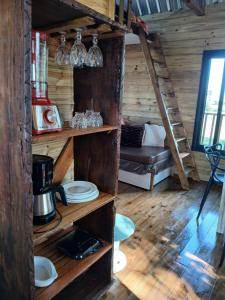 a room with wooden walls and wooden shelves with glasses at Casa na arvore Dream tree house in Santa Clara dʼOeste