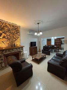 a living room with couches and a stone fireplace at Casa Familiar in San Rafael