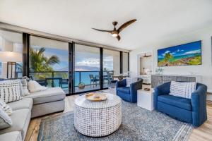 a living room with a couch and chairs and a table at KIHEI SURFSIDE, #501 condo in Wailea