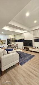 a large living room with a couch and a table at Nala Host - 2BR Apartment Seaside Bliss in Hulhumale