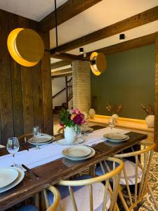 a wooden table with chairs and a dining room at Bradutul de la munte Chalet in Braşov