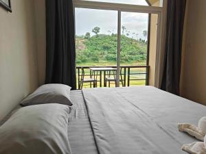 a bedroom with a bed and a window with a table at Moon lake resort 