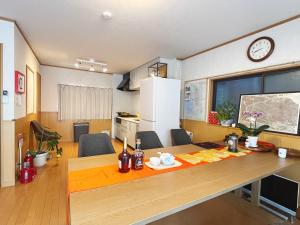 a kitchen and dining room with a large wooden table at 大阪一番駅 in Osaka