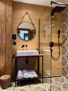 a bathroom with a sink and a mirror at Bradutul de la munte Chalet in Braşov