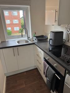 a small kitchen with a sink and a window at One bedroom studio in Moffat