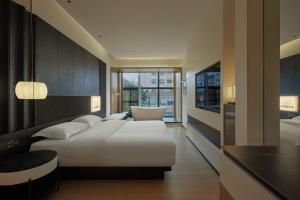 a hotel room with a bed and a chair at SFEEL设计师酒店Designer Hotel昆明南屏步行街店 in Kunming +35 photos
