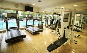 a gym with several tread machines in a building at Vivanta Bengaluru Residency Road in Bangalore