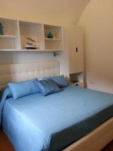 a bedroom with a large bed with blue pillows at Casa Vacanze Bouganvillea in Cetara