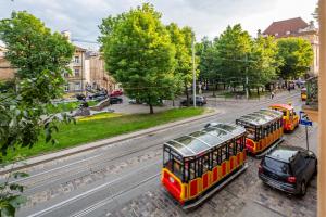 a group of buses parked on a city street at Crystal Apartments in Lviv
