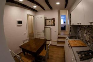 a kitchen with a table and a sink and a stove at Rosa Dei Venti in Riomaggiore