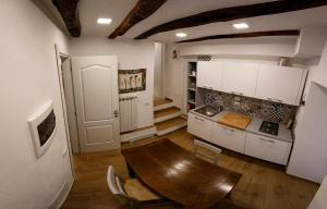 a kitchen with a wooden table in a room at Rosa Dei Venti in Riomaggiore