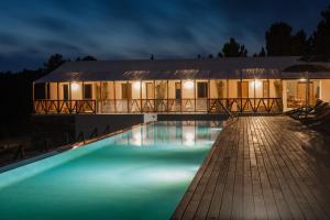 a villa with a swimming pool at night at TEIMA, Alentejo SW in São Teotónio