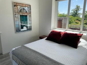 a bedroom with a bed and two windows at Udda boende med wow-känsla in Löderup