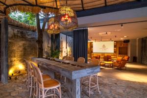 a lobby with a stone bar with chairs at Qingyuan Zhilin Hot Spring Bed and Breakfast in Qingyuan
