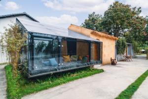 a glass extension of a house at Qingyuan Zhilin Hot Spring Bed and Breakfast in Qingyuan