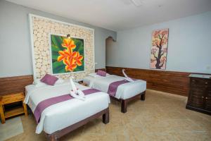 Postel nebo postele na pokoji v ubytování The Tanis Beach Resort Nusa Lembongan