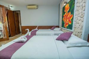 Postel nebo postele na pokoji v ubytování The Tanis Beach Resort Nusa Lembongan
