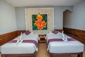 Postel nebo postele na pokoji v ubytování The Tanis Beach Resort Nusa Lembongan