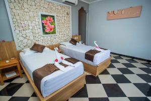 Postel nebo postele na pokoji v ubytování The Tanis Beach Resort Nusa Lembongan