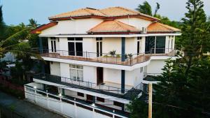 a large white building with a tiled roof at Ocean Villa in Trincomalee