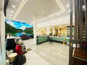 a large kitchen with a large painting on the wall at GREEN Hotel & Coffee in Bak Kan