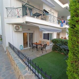 a balcony of a house with a table and chairs at R&T Apartments in Kallithea Halkidikis