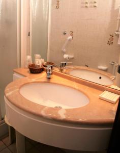 a bathroom with a sink and a bath tub at Hotel Delle Rose in Rapallo