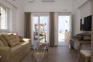 a living room with a couch and a table at Blue Horizon Villa & Suites in Sitia